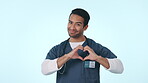 Face, doctor and man with heart sign, support or feedback on a blue studio background. Portrait, person or medical professional with symbol for love, review or kindness with emoji, icon or healthcare