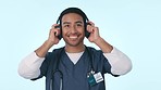 Listening, music and a man or doctor on a studio background for relax, sound and break from healthcare. Smile, podcast and an Asian nurse or medical employee streaming audio or radio on headphones
