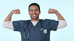 Doctor flexing muscle in studio, man with smile and power in healthcare career with pride and confidence. Hero in hospital, strong medical professional and happy nurse in uniform on blue background.