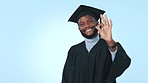 Pointing, ok sign and graduation of college student man in studio with advertising space. University graduate, education mockup and black person on a blue background for yes emoji or announcement