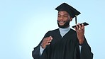 Graduation, college student and a man on phone call in studio for communication and good news. University graduate, education mockup and a black person talking on smartphone on a blue background