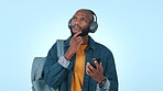 College student, thinking and phone with headphones for music streaming in studio. Black person listening to audio, sound or radio with backpack for university education and idea on a blue background