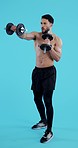 Fitness, gym and man with dumbbell for training, workout and exercise with healthy mindset and body. Personal trainer, person and athlete on blue background for wellness, muscle and cardio in studio