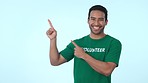 Mockup, pointing and face of man volunteer in studio for marketing, promotion or advertising. Choice, options and portrait of male community worker with approval hand gesture by white background.