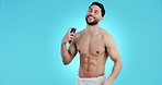 Body, spray and man with deodorant and perfume for cosmetic, hygiene and clean smell on blue background in studio. Antiperspirant, product and model with beauty, scent and wellness in self care