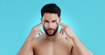 Face, eye patches and skincare of man in studio isolated on a blue background. Portrait, beauty and facial collagen mask of serious model for dermatology, cosmetics treatment and skin health at spa