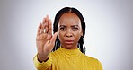 Black woman, hand and stop with face, warning or caution with rejection on white background. Protest, conflict and no, palm up and security with ban, anger or danger with prohibition in studio