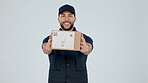 Delivery man, giving box and face, supplier and service with distribution isolated on white background. Portrait, e commerce and supply chain with package, mail and courier with product in studio