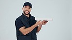 Smile, delivery and box with a courier man in studio on a gray background for shipping or logistics. Portrait, ecommerce or supply chain with a happy young postal worker for distribution of a package