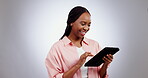 Woman, tablet and smile in studio with internet, social media update or search funny meme on grey background. Happy african model, digital technology and laugh for online shopping, scroll app or blog