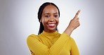 Face, smile and black woman with hand pointing in studio for contact, presentation or menu on grey background. Happy, portrait and African female model show steps, schedule or checklist and schedule