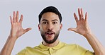 Face, wow and reaction of a mind blown man in studio on a gray background for a surprise revelation. Portrait, hands and news with a young person looking shocked by an announcement or gossip