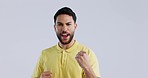 Face, man and success with fist in studio to celebrate deal, promotion and winning lotto prize on white background. Portrait, excited indian model and shout for celebration, bonus and pride of winner
