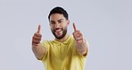 Face, smile and man with thumbs up, feedback and agreement on a white studio background. Portrait, person and model with hand gesture, mockup space and vote with emoji, review and support with a sign
