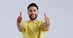 Face, smile and man with thumbs up, agreement and feedback on a white studio background. Portrait, happy person or model with hand gesture, mockup space and sign with emoji, icon and like with review