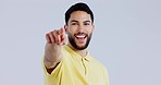 Face, pointing to you and man with a smile, motivation and support on a white studio background. Portrait, person or model with hand gesture, accountability or mockup space with selection or decision