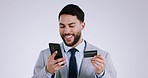 Phone, credit card and business man with online payment in studio with discount and app deal. Grey background, financial and male professional with web shopping and typing banking info for purchase