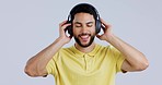 Man, music headphones and dancing in studio to celebrate freedom, party and audio media on white background. Happy indian model listening to peaceful podcast, hearing sound and radio with eyes closed