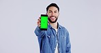 Happy man, face or green screen mockup on a phone for online branding or social media advertising. White background, smile or portrait of person pointing to mobile app chroma key logo space in studio