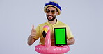 Green screen, tablet and funny man thumbs up sign for travel promotion isolated in studio gray background. Accept, thank you and agreement by person in inflatable summer costume as giveaway marketing