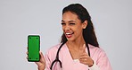 Doctor, thumbs up and phone green screen for medical services, registration and like, yes or ok in studio. Face of healthcare nurse or woman with mobile app and tracking marker on a white background 