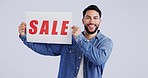Studio portrait of happy man with sale sign, discount and price promo isolated on white background. Smile, deal and excited model with presentation, announcement or poster with news card on offer.