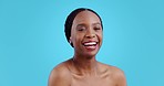 Skincare, beauty smile and black woman face with laughing and dermatology in studio. Blue background, happy African female person and skin glow portrait with cosmetics and makeup with wellness shine