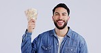Cash, money and winner man in studio for achievement, financial freedom and investment or tax return. Portrait of a Indian male on a grey background with savings award, loan or bonus lottery prize