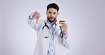 Doctor, thumbs down and donut in studio for food choice, review or advice for wellness by white background. Medic man, nutritionist and face for feedback with cake, dessert or diet for healthy eating