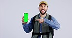 Hiking, green screen and man with phone pointing for gps mobile app, advertising and mockup space. Backpack, hand gesture and portrait of person on smartphone for website on studio gray background