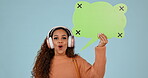 Speech bubble, portrait and woman with headphones in studio for voice, music or social media.Young person with announcement, wow feedback and streaming faq on a blue background with tracking markers