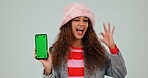 Green screen, phone and woman with perfect sign or hand gesture as review isolated in studio white background. Promotion, deal and young person with hand gesture for yes, like and ok symbol for app