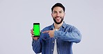 Happy man, face or green screen mockup on a phone for social media advertising or online branding. White background, smile or portrait of person pointing to mobile app chroma key logo space in studio