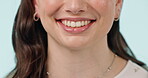 Woman, teeth and healthcare closeup with cosmetics, dental hygiene and veneers in studio. Dentist work, female person face and happy from mouth wellness and tooth cleaning with blue background