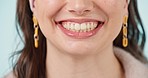 Woman, teeth and healthy smile closeup with cosmetics, dental hygiene and veneers in studio. Dentist work, female person face and happy from mouth wellness and tooth cleaning with blue background