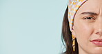 Half face, frown and confused with a woman in studio on blue background space for marketing. Portrait, doubt and question with a young person closeup on empty mockup for a logo or advertising