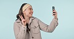 Happy woman, peace sign and selfie in photography or social media against a studio background. Excited female person smile with emoji for picture, photograph or online vlog in memory on mockup space