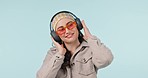 Dance music, fashion or studio woman smile for audio headphones, sound track or playlist song. Dancer, trendy or stylish person listening to popular podcast, radio network or media on blue background