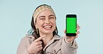 Happy, woman and green screen with phone for presentation of information, announcement or pointing with hand. Cellphone, mockup and smile on face for promotion on mobile app, ux or gen z show ui 