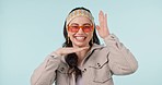 Fashion, face and happy woman with frame hands for casual clothes, trendy apparel or stylish outfit. Photography, fashionable style and portrait of model pose with studio glasses on blue background