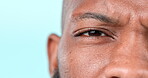 Confused, face and a black man on a studio background for question, doubt or thinking. Zoom, idea and closeup portrait of an African person with a frustrated expression and mockup space of an eye