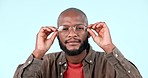 Vision, glasses and face of black man in a studio with optical health, wellness and eye care. Optometry, portrait and headshot of young African male model with spectacles isolated by white background