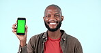 Happy face, phone and black man on green screen in studio isolated on blue background with tracking markers. Portrait, person smile and smartphone in advertising, mockup space or marketing promotion