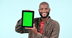 Happy black man, tablet and green screen in advertising or marketing against a studio background. Portrait of African male person smile holding technology display, app or mockup with tracking markers