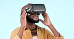 Virtual reality glasses, future and black man with digital app, augmented reality or software on a blue studio background. African person, gamer or model with VR eyewear, futuristic or tech with data