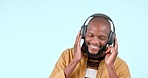 Happy black man, headphones and dancing to music or podcast against a studio background. African male person smile, listening or enjoying audio streaming, sound track or song playlist on mockup space