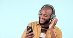 Music, happy and a black man with a phone for an app, streaming or singing to audio. Smile, African person and listening to the radio or sound on a mobile with headphones on a studio background