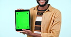 Green screen, tablet mock up and hands in studio with website, internet and social network. Ux, ui and closeup of a person with technology tracking markers, advertising or app on a blue background
