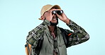 Bird watching, studio background and black man with binoculars while hiking or camping. Travel, vision and an African person with gear on a holiday for a search, adventure or looking while trekking 