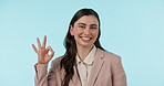 Sign, ok and portrait of business woman with hand in gesture for yes, like or thank you on blue background in studio. Okay, emoji and expression for promotion, agreement and happy for success